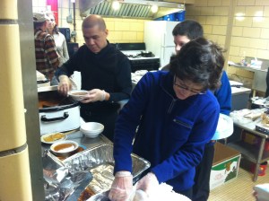 Father Joseph Sia and Linda DePuydt volunteered to help serve a meal for Loaves & Fishes on Feb. 23 at MCSA.