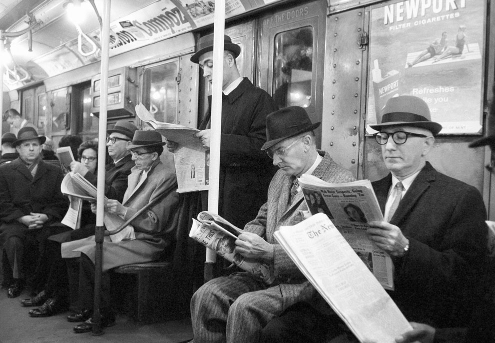 Riders read their morning newspapers on New York's subway en route to work, on April 1, 1963 after the end of the city's 114-day newspaper strike. (AP Photo/Jacob Harris)