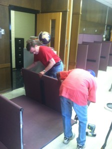 Tom Curry, left, MCSA building manager, works with resident Michael Vivians to empty out the Learning Center at MCSA.